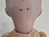 a small doll that has a face on top of it
