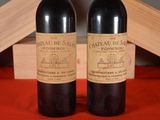 two bottles of wine sitting next to each other on a table