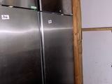 a stainless steel refrigerator in the corner of a room