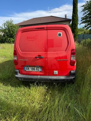 a red van that is parked in the grass