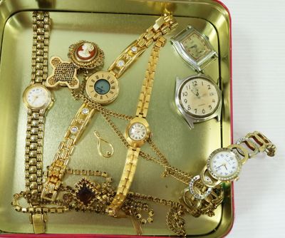 many different types of watches in a metal tray