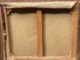 an old picture of a wooden frame with a painting on it