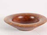wooden bowl on a white surface with a white background