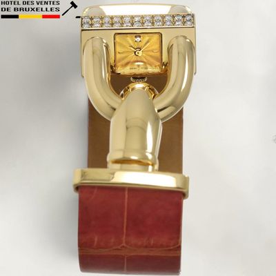 a gold watch on a red leather strap with diamonds on it