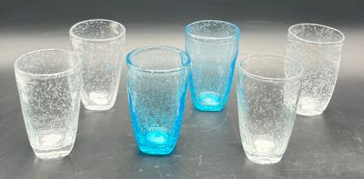 six glasses that are sitting on a table