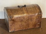an old suitcase sitting on the floor next to a wall