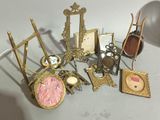 a lot of antique picture frames and pictures on the table