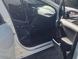 a white van with the door open and the driver ' s seat down