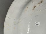 a white plate with a brown spot on it