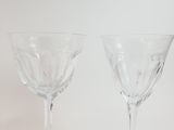 two wine glasses sitting next to each other on a table