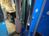a blue locker with a green towel hanging on it