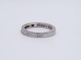 a close up of a wedding ring with a diamond in it