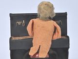 a teddy bear that is sitting on top of a piano