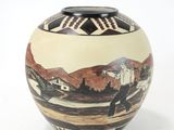 a vase that has a picture of a town on it
