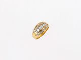 a yellow gold ring with baguets of diamonds on a white background