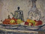 two plates of fruit on a table next to a bottle