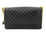 a black quilted purse with a gold chain strap