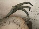 a sculpture of a bird that is on top of a rock