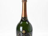 a close up of a bottle of champagne on a white surface