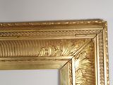 a picture of a gold framed mirror on the wall