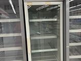 two empty refrigerators in a store that are empty