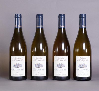 four bottles of wine are lined up on a table