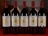 four bottles of wine are lined up on a table