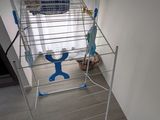 a baby in a toy car next to a laundry basket