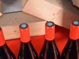 several bottles of red wine are lined up on a table