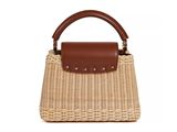 a brown and white straw bag with a brown handle
