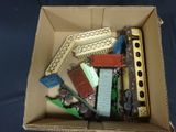 a box full of toy trains sitting on a blue surface