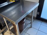 a stainless steel table with a pot on it in a kitchen
