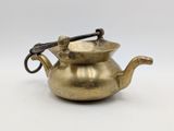 an old brass teapot with a handle on a white background