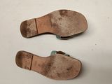 two pairs of shoes are sitting on a white surface