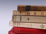 many books stacked on top of each other on a table