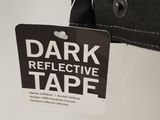 a tag that reads dark reflective table hanging from the back of a jacket