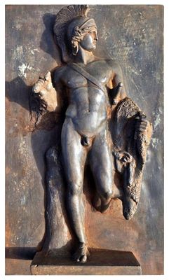a statue of a man holding a bull on a wall
