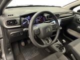 the interior of a car with a steering wheel and dashboard controls