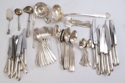 a lot of silver spoons and knives on the table