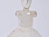 a clear glass bottle with a stopper on top of it