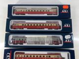 three red and white train cars sitting on top of each other