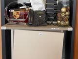 a small refrigerator in the corner of a room