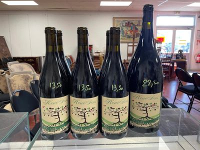 six bottles of wine sitting on top of a table in a store