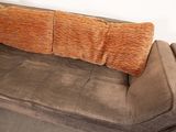 a couch that has a pillow on top of it