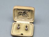 a small box with a pair of earrings inside of it
