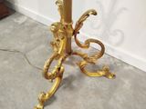 a gold table with a marble top and a gold base