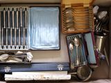 a box with a bunch of silverware in it
