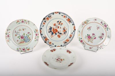 three plates and a bowl are sitting on a white surface