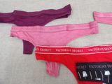 three women ' s underwear are lined up on a bed