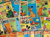 a pile of mickey mouse comic books on a table